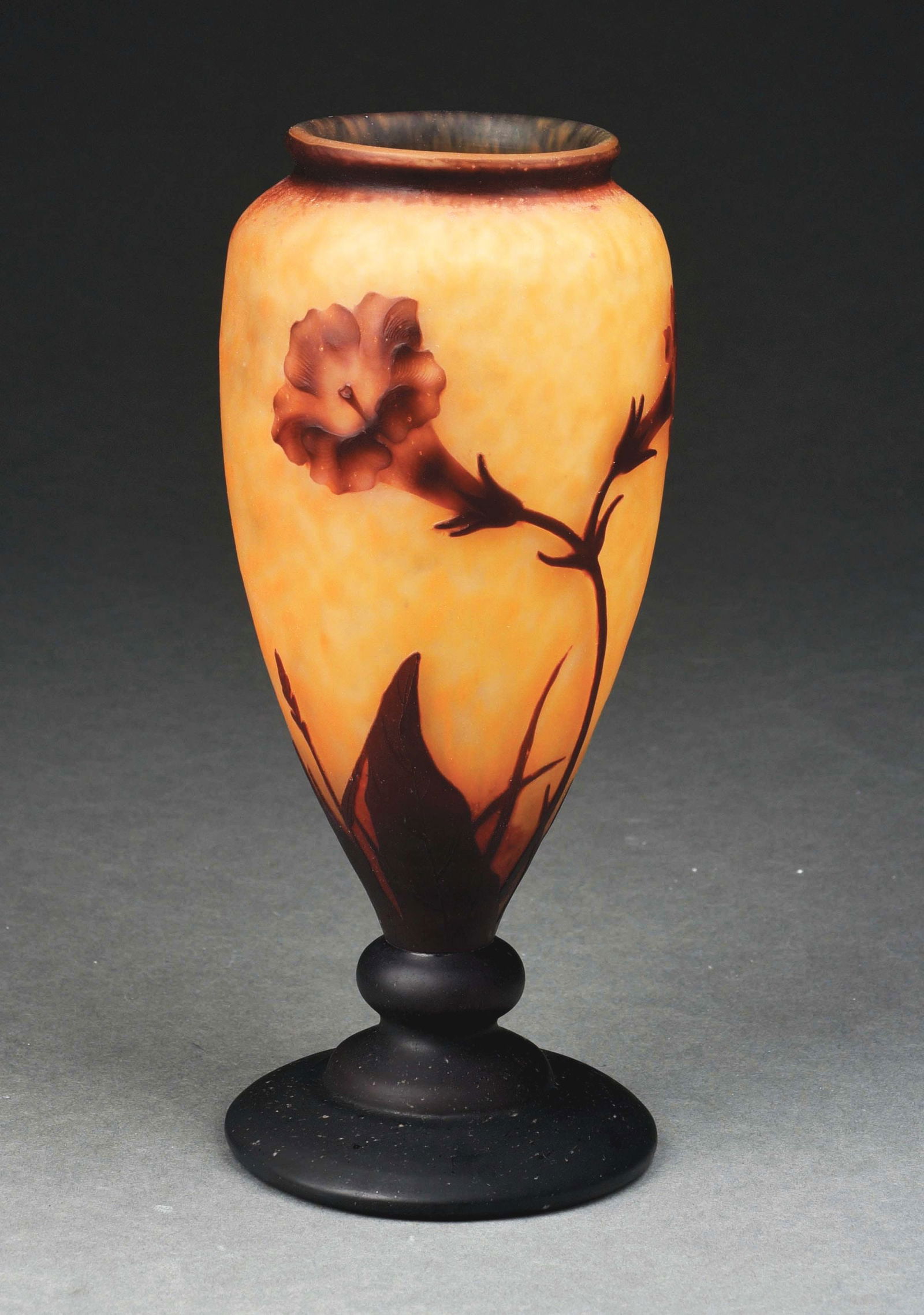 DAUM NANCY TRUMPET FLOWER (BIGNONES) VASE.: A gorgeous Bignones vase by Daum Nancy. The 10" tall vase has a background of highly mottled orange and cream-colored glass. The vase is further decorated with cameo cut trumpet flowers in deep purple