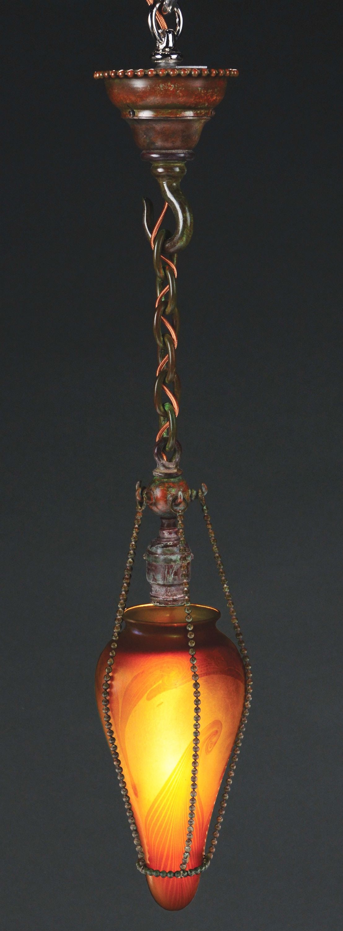 TIFFANY STUDIOS STALACTITE CHANDELIER.: A lovely stalactite chandelier by Tiffany Studios. The 10" glass conical shade features a background of gold glass with soft iridescence, embellished with darker gold swirling lines throughout. The in