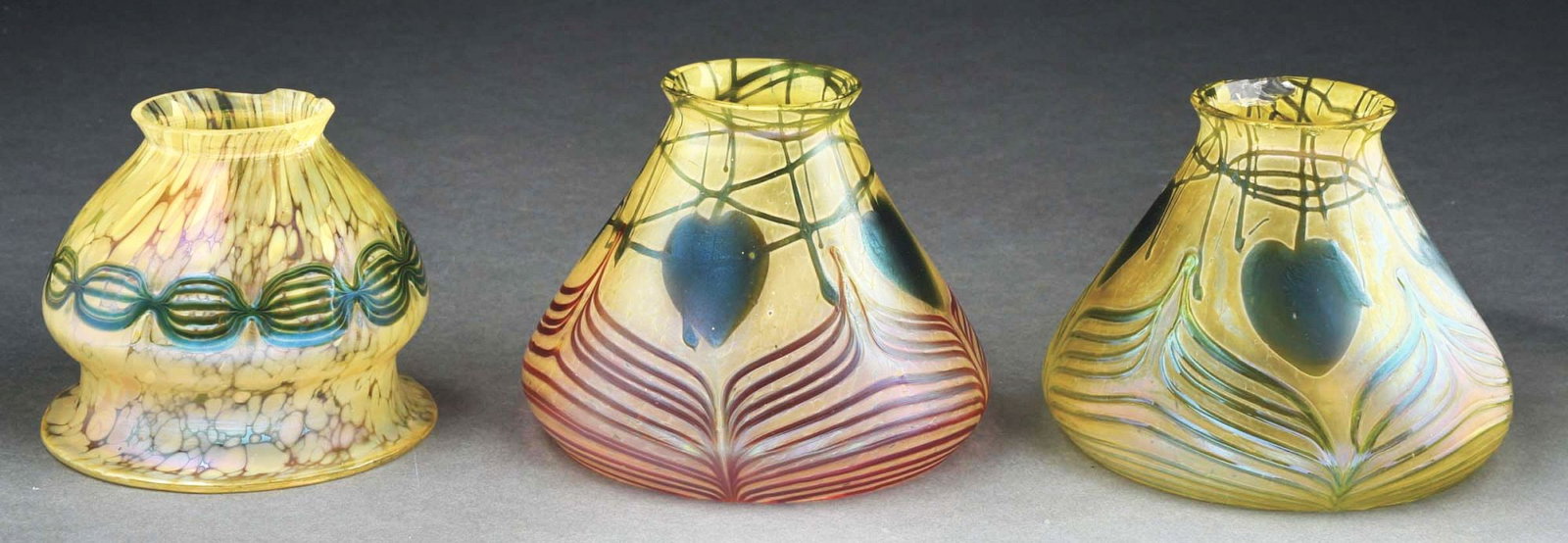 LOT OF 3: LOETZ ART GLASS SHADES.: A very nice set of three glass shades by Loetz. All three shades have a frosted green background with oil spot pattern. Two of the shades are decorated with a green leaf and vine pattern, while the th