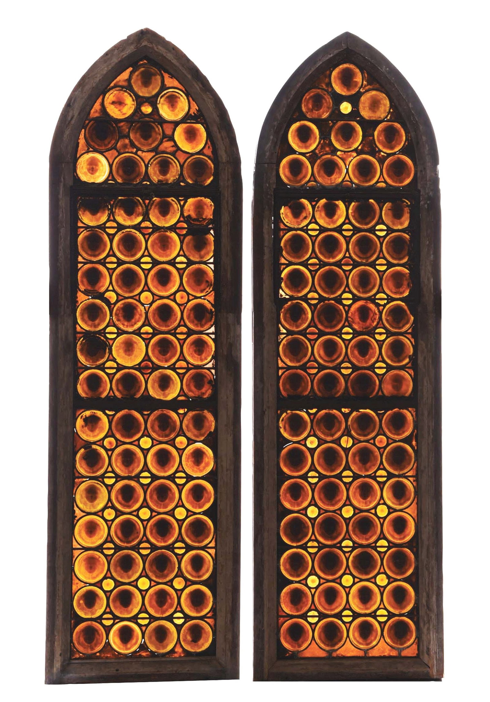 PAIR OF TIFFANY STUDIOS CHERUB ROUNDEL STAINED GLASS WINDOWS.: A lovely pair of stained glass windows in their original wooden frame by Tiffany Studios. Each window stands approximately 100" by 29 - 1/2" in its frame. Each window is composed of a series of 62 amb
