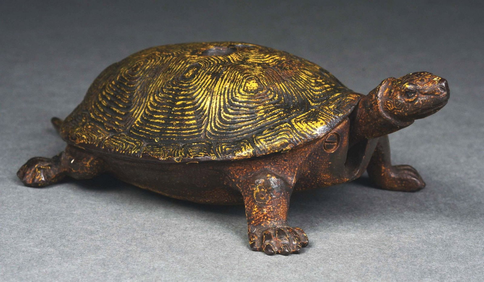 COUNTERTOP TURTLE CIGAR CUTTER.: Highly unusual, this cigar cutter was probably found on the counter in the store to be used by patrons. When the head of the turtle is pushed down, the cutter on the top of the shell closes and cuts t