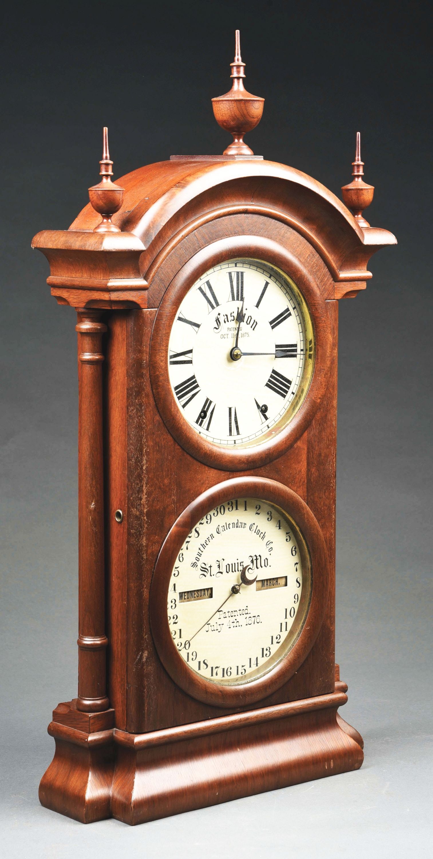 SETH THOMAS SOUTHERN CALENDAR FASHION # 2 DOUBLE DIAL CLOCK: This an 8-day clock striking on the hour. CONDITION: Mahogany case and finials with repainted dials. The calendar drum dial faces, both month and day, are original to the clock. The manufacturers labe