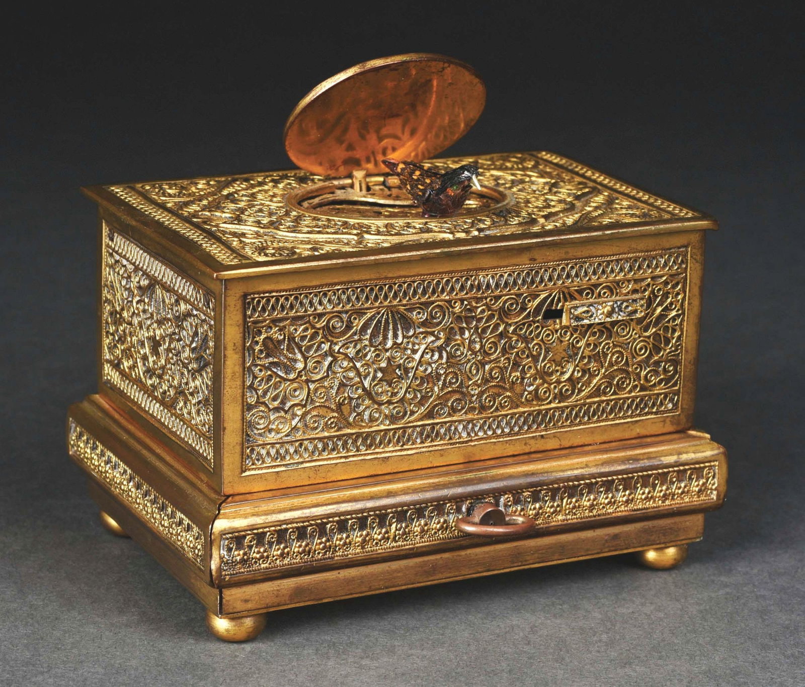 KARL GRIESBAUM MECHANICAL SINGING BIRD BOX SNUFF BOX: This fantastic German bird box is in pristine condition and works perfectly. Great brass detailed box, beautiful colors to the bird and sharp, crisp sound. Has a snuff compartment drawer and key. COND