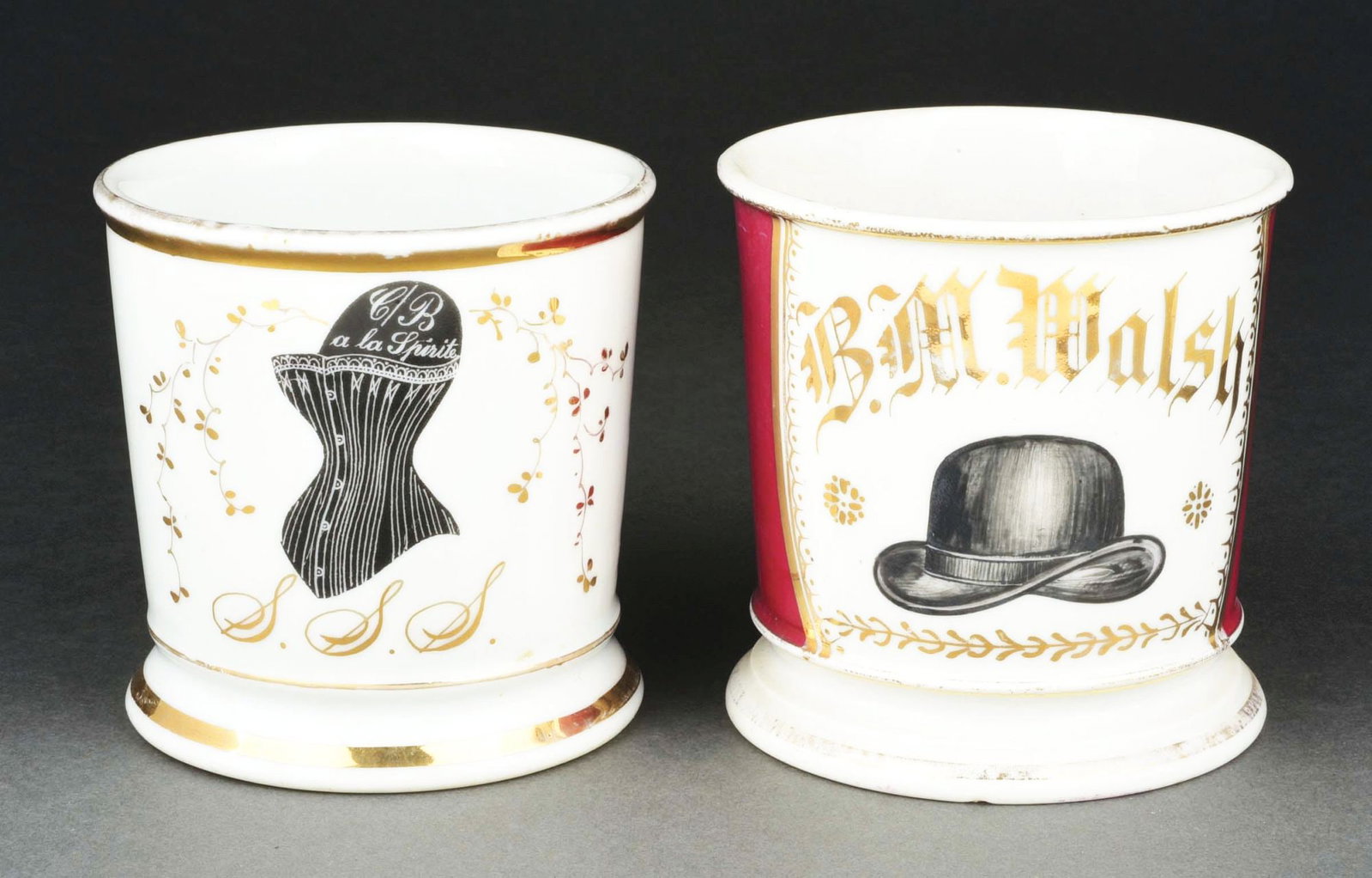 LOT OF 2: CLOTHERS SHAVING MUGS.: Includes hat producer and corset producer mugs. Condition: (Excellent). Item Dimensions: Largest: 4 - 3/4" x 3 - 3/4" x 3 - 3/4".