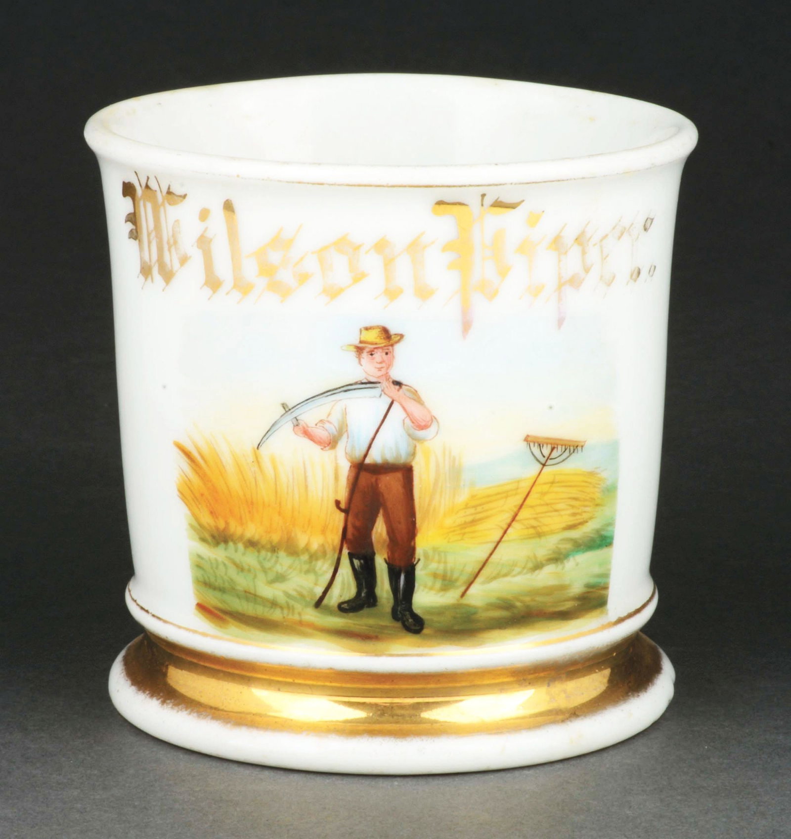 FARMER SHAVING MUG.: Has the name "Wilson Piper" in gold gilt. Stamped "D&C" under base. Nice image of farmer holding rake. Condition: (Excellent). Item Dimensions: 4 - 1/2" x 3 - 1/2" x 3 - 1/2".