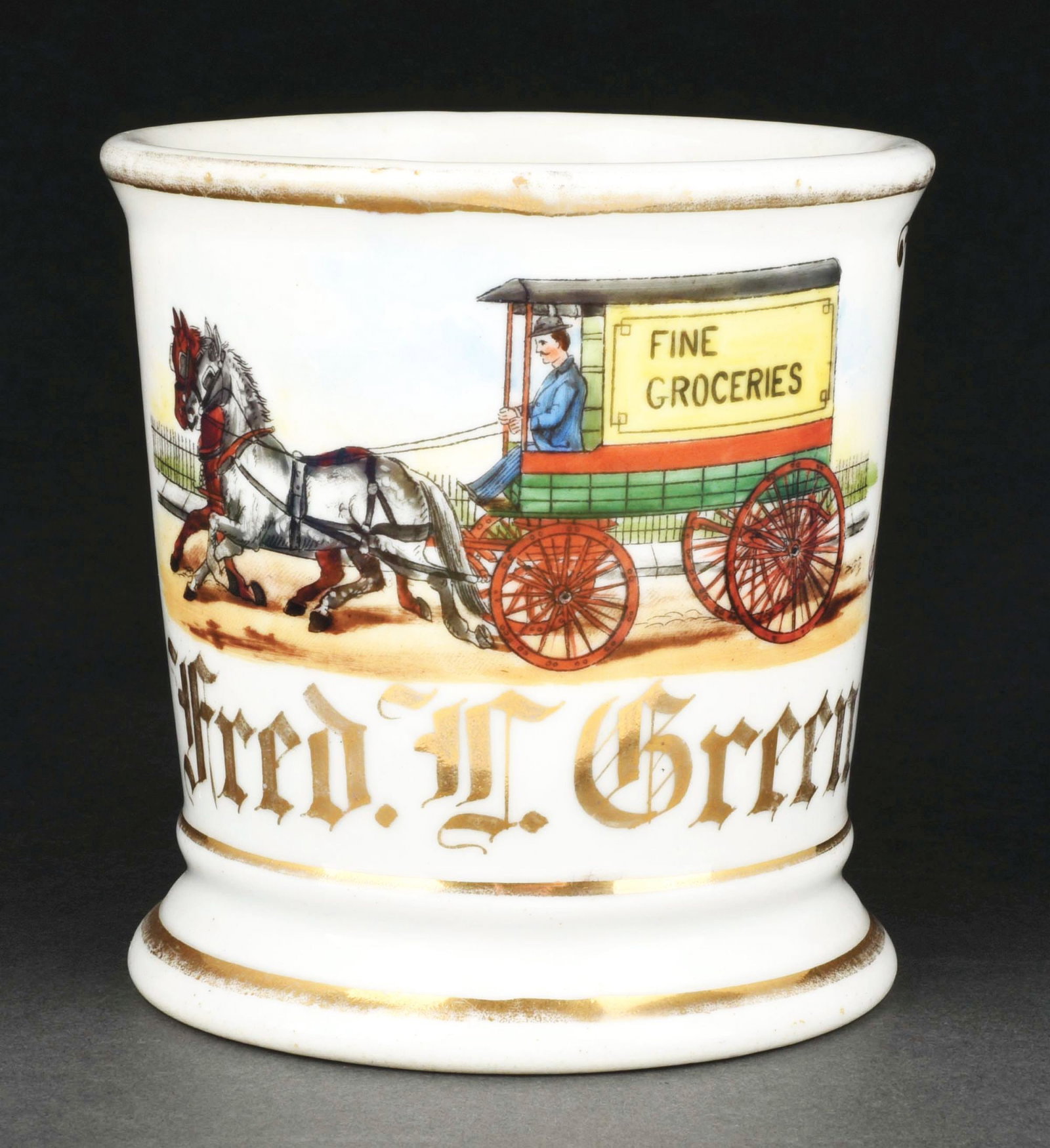 HORSE-DRAWN GROCERY DELIVERY TRUCK SHAVING MUG.: Has the name "Fred L. Green" in gold gilt. Detailed image of man driving a horse-drawn grocery truck. Condition: (Excellent). Item Dimensions: 4 - 3/4" x 3 - 3/4" x 3 - 3/4".