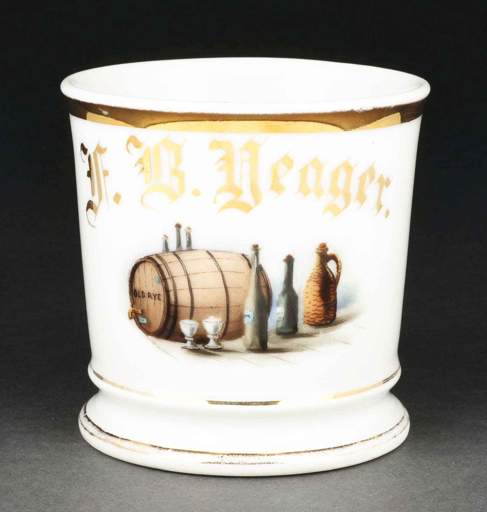 WHISKEY PRODUCER SHAVING MUG.: Has the name "F.B. Yeager" in gold gilt. Mug is stamped "D&C" under base. Beautiful image of a rye keg and miscellaneous bottles. Condition: (Excellent). Item Dimensions: 4 - 1/2" x 3 - 1/2" x 3 - 1/2
