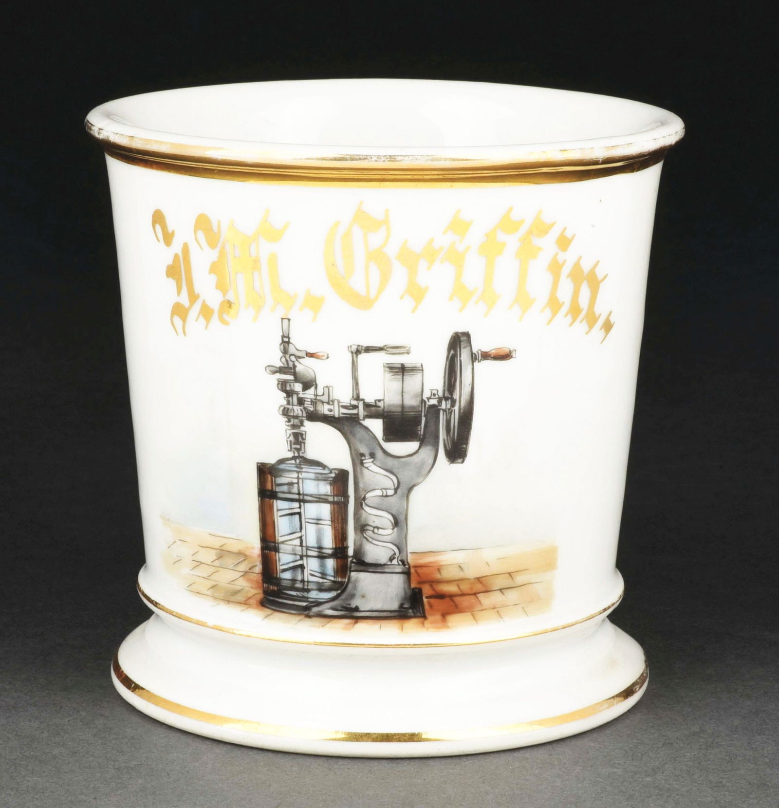 DRILL MACHINE OPERATOR SHAVING MUG.: Has the name "J.M. Griffin" in gold gilt. Mug is stamped "Limoges France" under base. Detailed image of a hand-operated drill press. Condition: (Excellent). Item Dimensions: 4 - 1/2" x 3 - 1/2" x 3 -