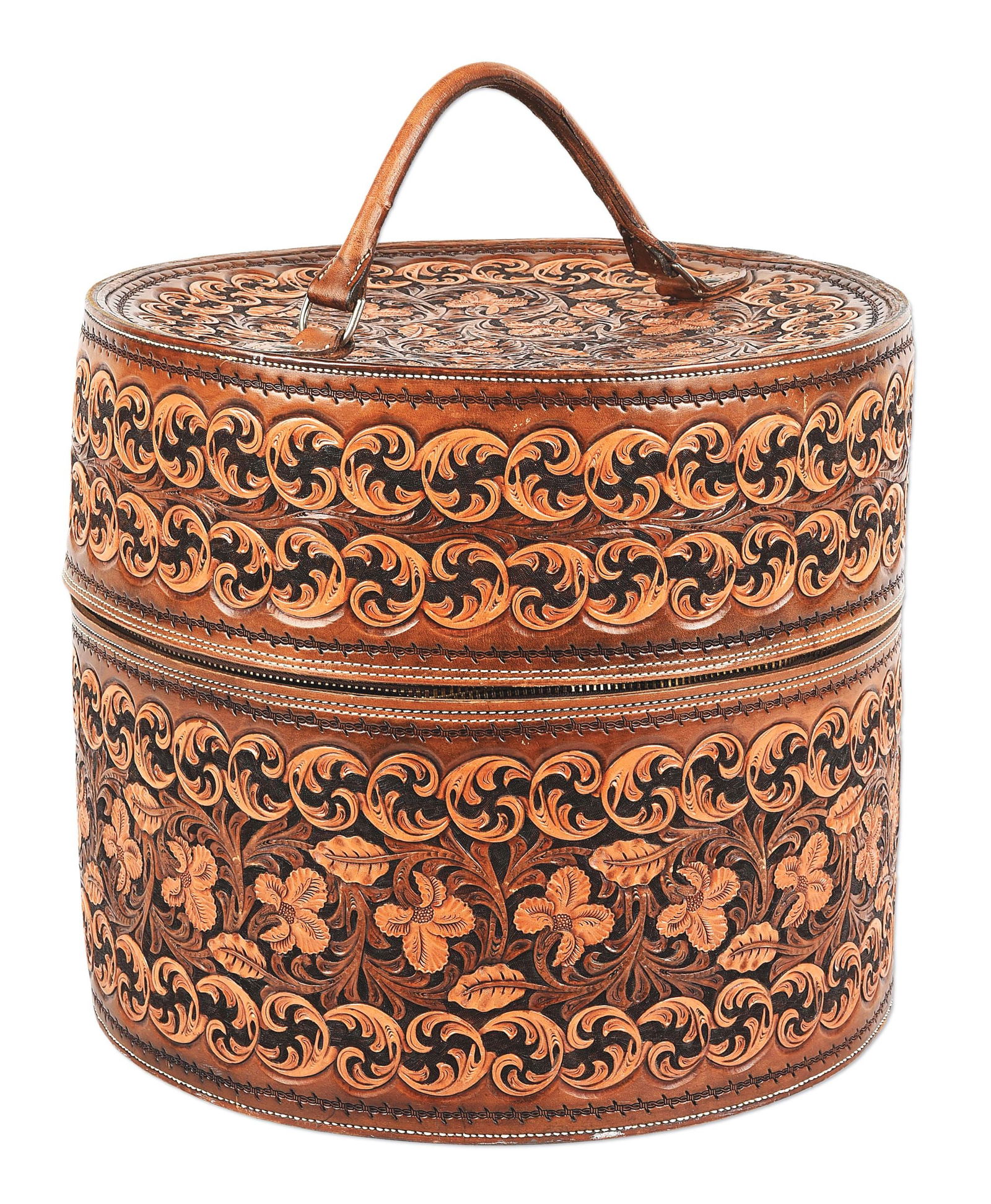 BOB DELLIS HAND CARVED LEATHER HAT BOX W/ O'FARREL HAT: A hard sided round leather hat case with tight scroll and floral designs in two-tone browns. 14" tall by 16" diameter. Inside we find a beautiful brown hat with bound edge by Kevin O'Farrell, Canyon R