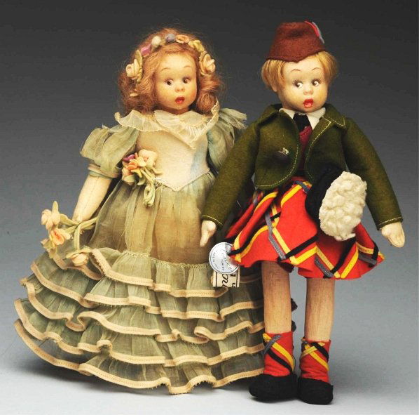 Lot of 2: Miniature Lenci Dolls.: Molded felt faces with surprised side-glancing eyes, painted upper eyelashes, open/closed mouths. Original clothing on both dolls. Both have two Lenci tags. Light fading and soil on clothing, organdy