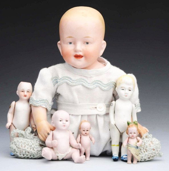 Lot of 6: All Bisque Dolls.: Large baby incised with Limbach clover and 8660, painted blond hair, intaglio eyes, jointed shoulders and hips (fingers repaired); pink bisque German baby; two pink bisque Hertwig characters; German d