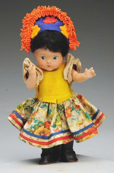 Vogue Composition “Toddles” Doll.: All composition marked “Vogue” with blue painted eyes, black mohair wig, (light overall crazing); factory Brazilian costume with black boots look original, but untagged. Condition (Very Good). Siz