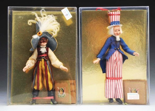 Lot of 2: Cynthia Baron Original Dolls.: Sculpted faces, hands and legs with cloth bodies. “Uncle Sam” 1997 and “Harlequin” 1996 both #5 of a limited edition of 100. Beautifully detailed work, with wrist tags in original boxes. Condi