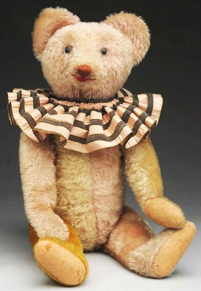 Rare Clown Teddy Bear.: German mohair bear, possibly by Schuco about 1930 with four-colored body parts and music box which operates when the head is moved, unusual neck mechanism, red sewn mouth and brown sewn nose, clown ru