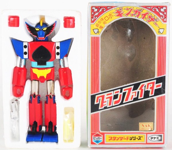 Gingaizer.: Takemi. Premium character in the Takemi line of three. Gingaizer has a magnetic stick on face, firing fists, point swords, and then a fold down chest launcher. Condition (Near Mint Plus). Size Box: 7"