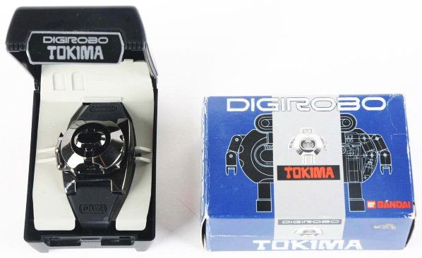 Bandai Digirobo Watch.: Popy. Capitalizing on the digital watch craze, this Bandai Digirobo watch is surprisingly difficult to find in new old stock condition. This gunmetal gray version robot can release from a watch band a