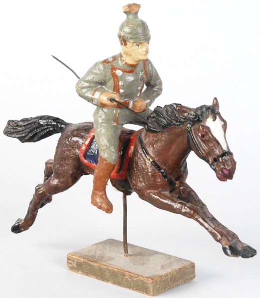 Elastolin Lancer on Springing Horse.: Composition horse and rider. Slight damage to tip of helmet. Condition (Very Good - Excellent). Size 6" L.