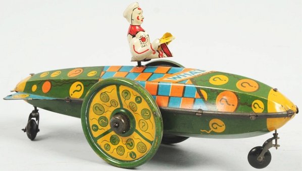 Tin Litho Strauss What's-It? Car Wind-Up Toy.: American. Working. Scarce car with replacement figure. Interesting lithographed pattern on car. Condition (Very Good). Size 9 - 1/2" L.