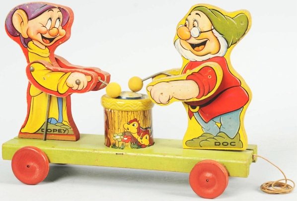 Fisher Price Disney 770 Doc & Dopey Pull Toy.: Marked "1937 Walt Disney Enterprises". Replaced drumhead and mallet heads. Some staining and creasing to paper. Condition (Very Good). Size 12" L.