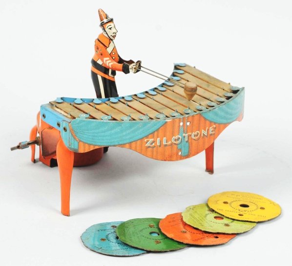 Tin Litho Wolverine Xylophone Player Wind-Up Toy.: American. Works well. Includes six records. Some tarnishing to keys and some scratching to base. Condition (Very Good). Size 7 - 1/2" T.