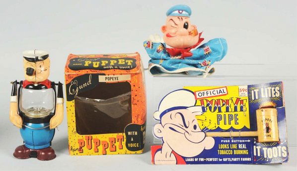 Lot of 3: Vintage Popeye Character Toy Items.: Includes one tin Linemar Popeye Lantern, one Popeye Pipe on original card marked "1958 King Features Syndicate", and one Gund hand puppet in original box. Condition (Very Good - Excellent). Size Large