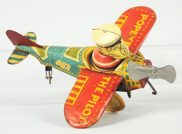 Tin Litho Marx Popeye the Pilot Wind-Up Toy.: American. Working. Replacement head, pipe, and back tail fin. Some scratching and wear throughout. Condition (Good - Very Good). Size 8" Wingspan.