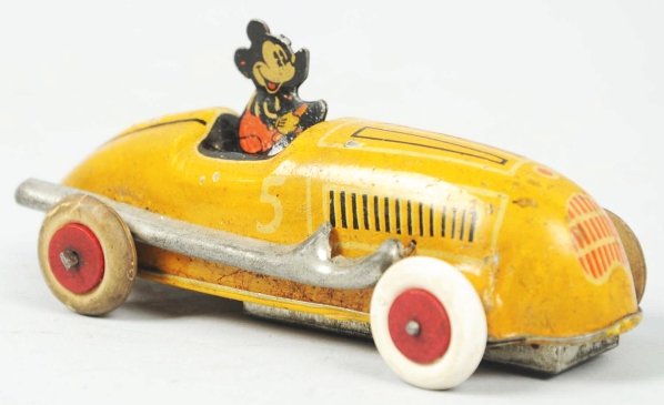 Tin Litho Disney Mickey Mouse Car Wind-Up Toy.: Working. Marked "Made in USA" and "5" on both sides of car. White rubber tires with red wooden hubs (one tire is replaced). Nice tin litho figure of Mickey driving Speedway car. Some scratching and we