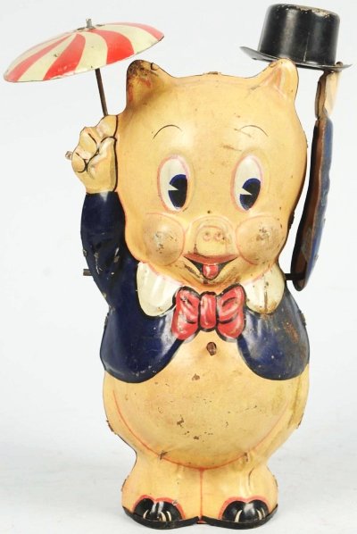 Tin Litho Marx Porky Pig with Top Hat Wind-Up Toy: American. Working. Marked "1939 Leon Schlesinger". When wound, left arm moves up and down with top hat and umbrella spins. Toy has overall scratching and wear and some oxidation to left side of chest.