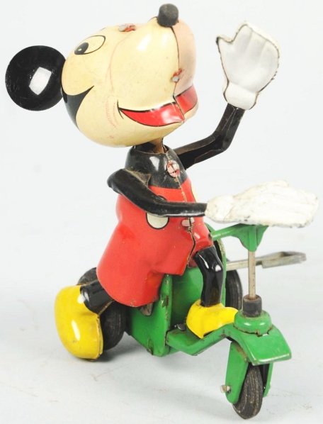 Tin Linemar Disney Mickey on Scooter Wind-Up Toy.: Japanese. Working. One of the scarcer Linemar toys. Marked "Walt Disney Productions" on bottom. Original arms and ears. Sides of face are two different colors (due to production error) but are origina