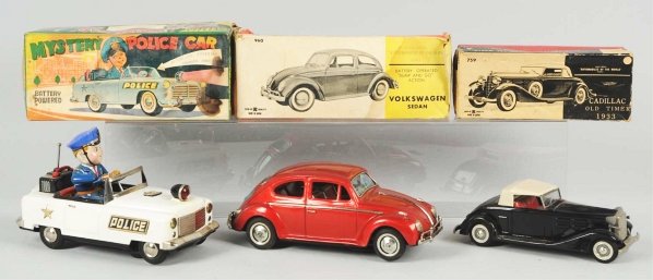 Lot of 3: Vehicle Battery-Op & Friction Toys.: Japanese. Includes one battery-operated Bandai Volkswagen with box that has some staining and is missing bottom. Also includes Mystery Police Car with box that has some staining and one friction Old T