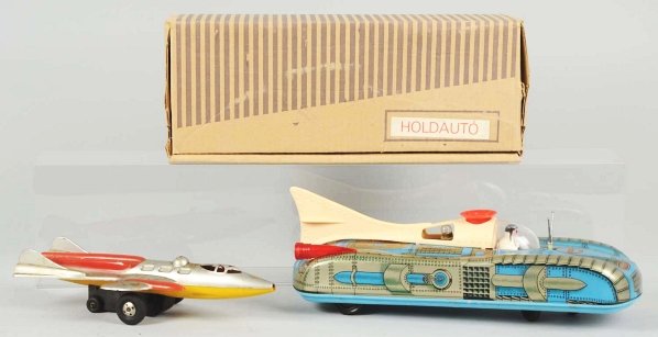 Lot of 2: Tin & Plastic Space Toys.: Includes one scarce friction Rocket Toy and one Hungarian battery-operated Space Car in original box marked "Holdauto". Condition (Very Good - Excellent). Size Largest: 13 - 1/2" L.