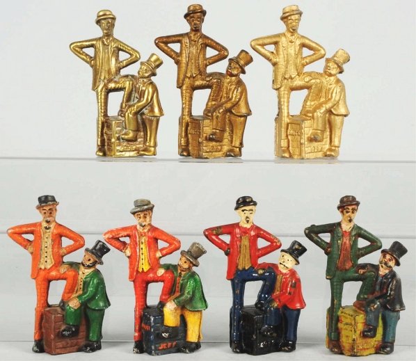 Lot of 7: Mutt & Jeff Still Banks.: Includes five cast iron versions, three lead white metal versions, and one brass version. Most likely later productions from an original mold. Condition (Excellent). Size Each: 5 - 1/4" T.