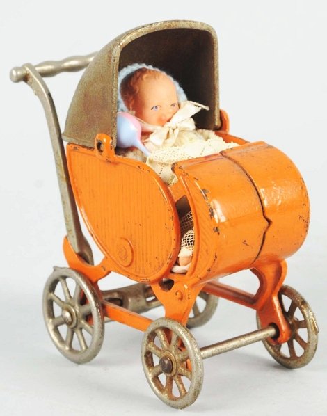 Cast Iron Kilgore Baby Carriage Toy.: American. Includes period doll that is original but not to this toy. Large size variation with nickel wheels. Some pitting and oxidation to bare metal parts. Condition (Very Good - Excellent). Size 5