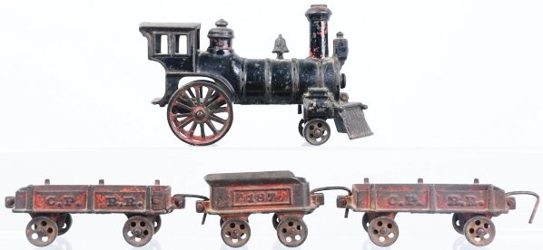 Early American Cast Iron Freight Floor Train.: Circa 1880s. Includes one four-wheel steam engine with cowcatcher, no. 187 tender, and two CPRR ore cars. All items have significant paint loss and wear. Condition (Good - Very Good).