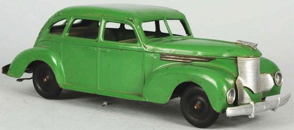 Pressed Steel Keystone Automobile Wind-Up Toy.: American. Separate tin grille with black rubber tires. Some oxidation to bare metal parts and pitting to bottom mechanism casing. Also, some scratching and wear overall. Condition (Very Good - Excelle