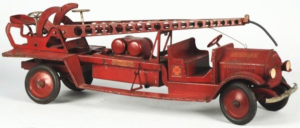 Pressed Steel Sturditoy Water Tower Truck Toy.: "American-La France" decals on both sides, marked "Water Tower No. 9" on both sides of hood, and "Sturditoy" on front. This is a hard-to-find truck. Some paint loss and wear to fenders and hood. Condi