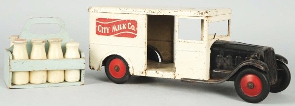 Pressed Steel Steelcraft City Milk Co. Truck Toy: Battery-operated headlights and City Milk Company decals on both sides of rear. Some paint loss throughout, especially to cab roof and fenders. Also comes with a wooden crate of eight wooden milk bott