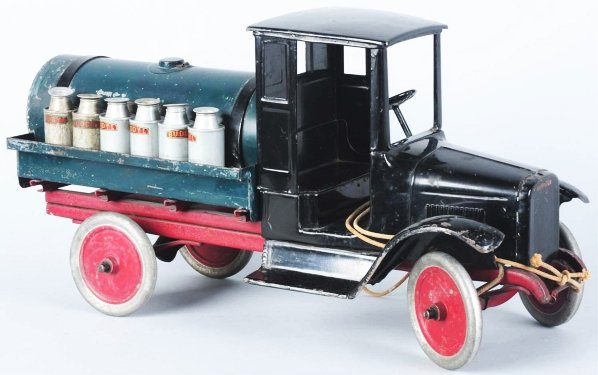 Pressed Steel Buddy L Tank Line Truck Toy.: American. "Buddy L Tank Line" decals on rear. Includes original spreader bar, cap, spout, and six milk cans (two original and four reproductions). Decals have some chipping on the front and truck has 