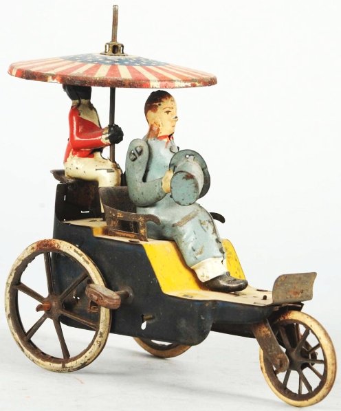 Tin Litho Lehmann Onkle-Onkle Wind-Up Toy.: German. Depicts man in front, waving hat in one arm, and an African American man in back holding parasol. Toy has some litho loss and some areas of rust on umbrella. Mechanism needs to be oiled and pa