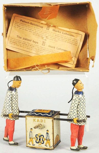 Tin Litho Lehmann Kadi Wind-Up Toy.: German. Working. All original. Some wear to faces and gold wash striping. Includes original box bottom and patent sheet. Condition (Very Good - Excellent). Size 7" L.