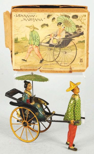Tin Litho Lehmann Masuyama Wind-Up Toy.: German. Working. Toy is all original including fan and umbrella and has very little wear. Includes original box with some tearing and creasing to lid. Box is also missing one side apron and part of an
