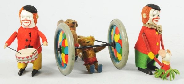 Lot of 3: Plush Schuco Wind-Up Toys.: German. Working. Includes one drumming clown, one clown dancing with mouth, and one mouse pushing a small teddy bear on trapeze wheel. Some moth-holes to clothing. Condition (Very Good). Size Largest:
