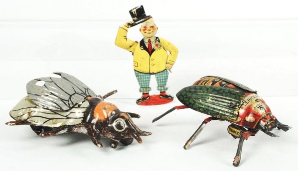 Lot of 3: Tin Litho Toys.: German. Includes one wind-up Lehmann Beattle, one wind-up Fly, and one CKO man tipping his hat squeeze toy. Moderate overall scratching and wear. Condition (Very Good). Size Largest: 4" L.