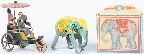 Lot of 2: Tin Litho Character Wind-Up Toys.: German. Includes one Lehmann Onkel-Onkel that is not working, has some paint loss and wear to figures, some denting to top umbrella. Also includes one Jumbo Walking Elephant with colorful original box