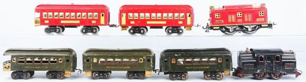 Lot of 2: Lionel Passenger Train Sets.: American. Standard gauge. Includes no. 8 engine with two passenger cars and no. 33 electric style engine with three passenger cars. All pieces have some scratching, paint loss, and wear. Condition (Ve