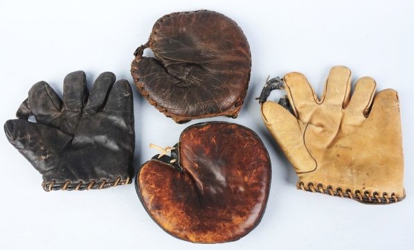 Lot of 4: Baseball Gloves & Catcher's Mitts.: Includes adult and children's models. One Buckle Back glove and one with a nice "Gold Smith" label. Condition (Good - Very Good). Size Largest: 10 - 1/2" x 10".