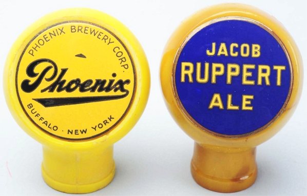 Lot of 2: Phoenix & Jacob Ruppert Beer Tap Knobs.: The Jacob Ruppert Ale tap knob has a clean, bright face and bakelite tap. The Phoenix Beer tap knob has a clean face with slight wear and some discoloration to tap handle. Condition (Very Good).