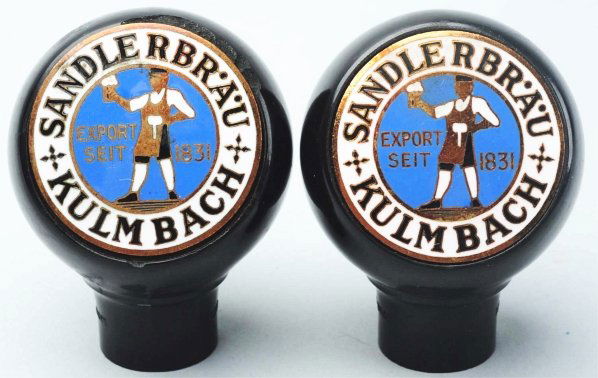 Lot of 2: Sandlerbrau Kulmbach Beer Tap Knobs.: Both with bright colors and just very light wear to face. One with clean tap and the other with some chipping around edges. Condition (Good - Excellent).