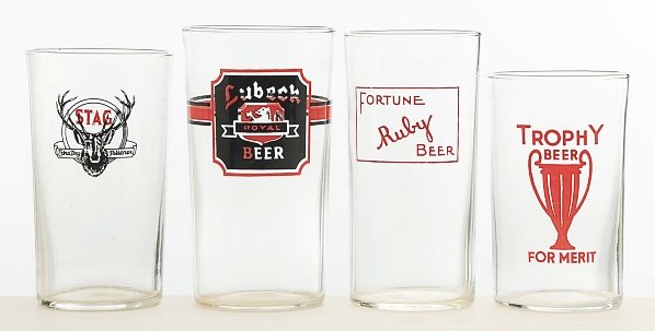 Lot of 4: Enameled Beer Glasses.: Includes Lubeck, rare Trophy Beer, Stag, and rare Ruby Beer. All four glasses are in wonderful condition and are nice, bright examples. Condition (Excellent - Near Mint). Size Largest: 4 - 3/4" T.