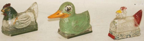 3 Glass Candy Containers.: Includes one hen on nest with original tin closure, one hen on weaved base with original tin closure and one large bill duck with 10% paint. Condition (Excellent). Size Largest: 4 - 3/4" L.